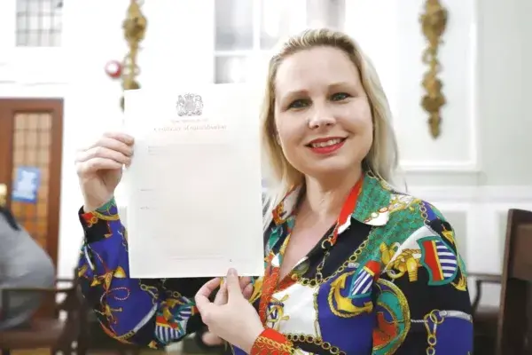 Teacher Gra holding her UK certificate