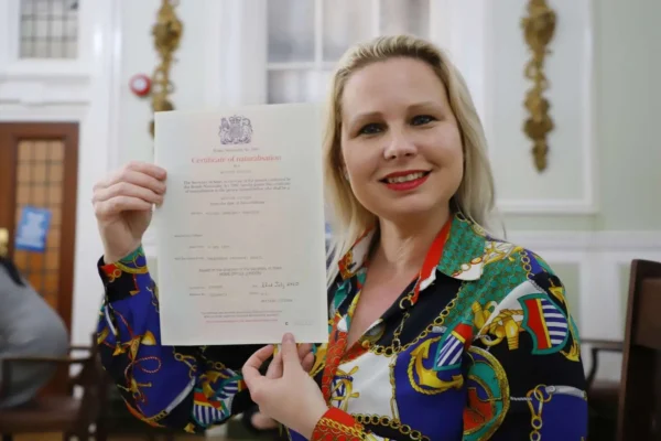 Teacher Gra holding her Cambridge CELTA certificate