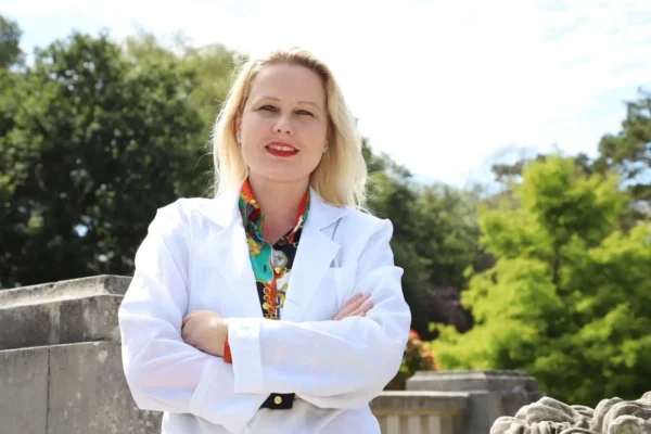 Teacher Gra outdoors in white lab coat